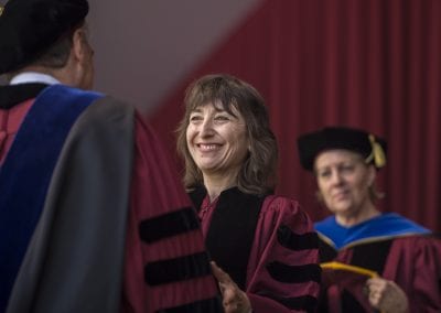 University Marshal Catherine C. Baumann, right, prepares to hood astronomer Wendy L. Freedman as she receives an honorary degree of Doctor of Science from University President Robert Zimmer during the University of Chicago's 519th Convocation Saturday, June 14, 2014. (Robert Kozloff/The University of Chicago)